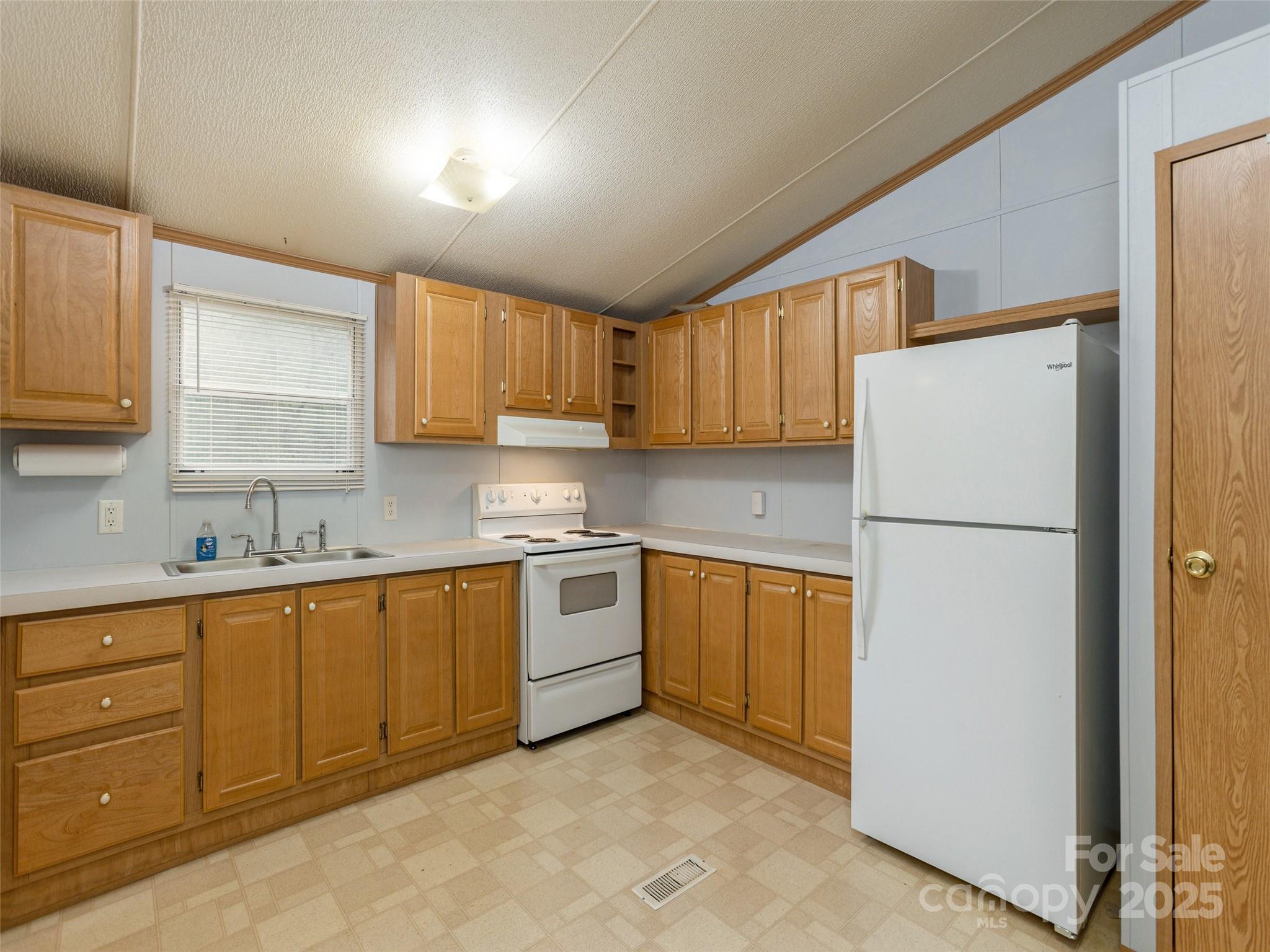 81 Mt Airy Road Marshall, NC 28753 - Photo 7 of 19 a kitchen with stainless steel appliances granite countertop a refrigerator sink and cabinets