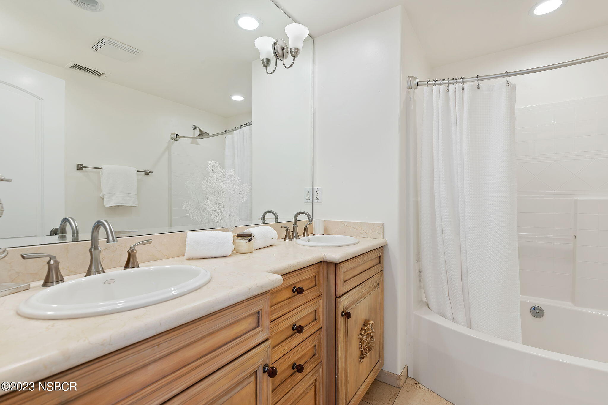 4366 Modoc Road Santa Barbara, CA 93110 - Photo 18 of 23 a bathroom with a double vanity sink and a mirror