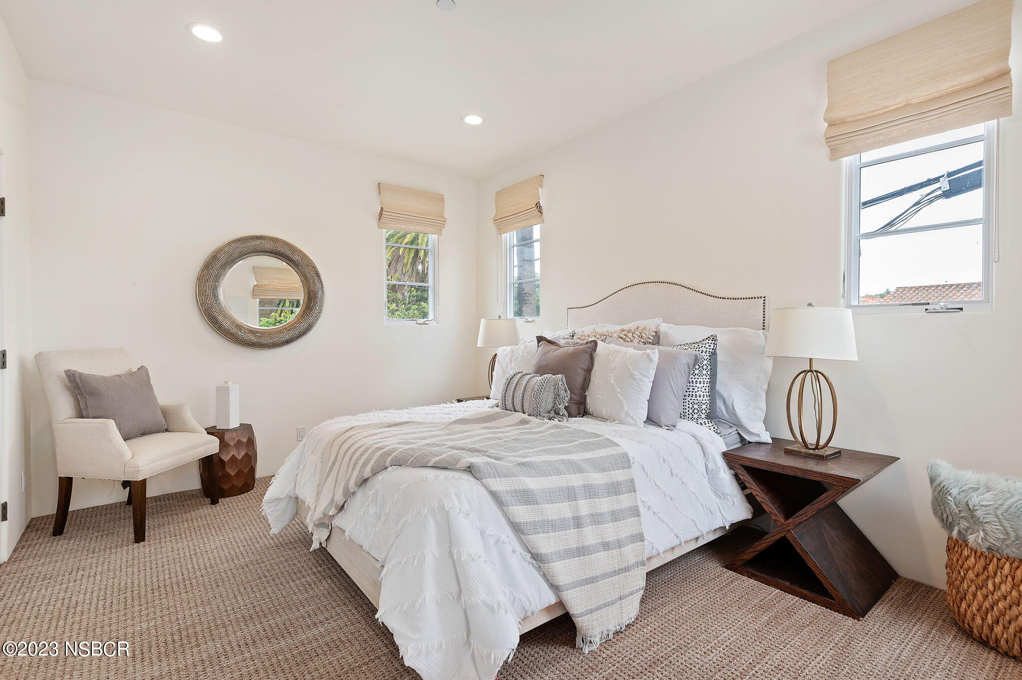 4366 Modoc Road Santa Barbara, CA 93110 - Photo 19 of 23 a bedroom with a bed a clock and a large mirror