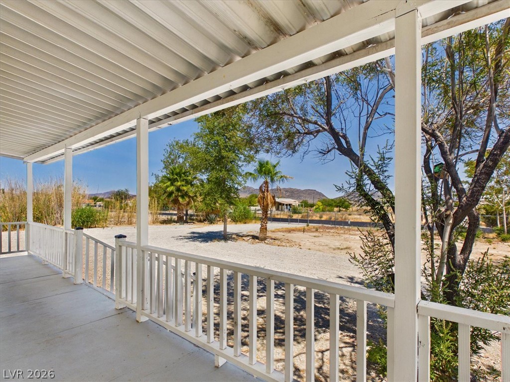 4081 Retread Road Pahrump, NV 89048 - Photo 72 of 98 An inviting front porch provides a pleasant spot to relax and survey the expansive landscape under clear skies.