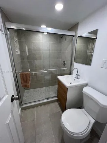 a bathroom with a toilet sink and shower