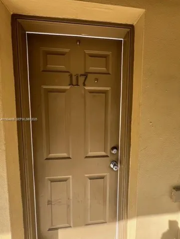 a front view of a building with potted plants