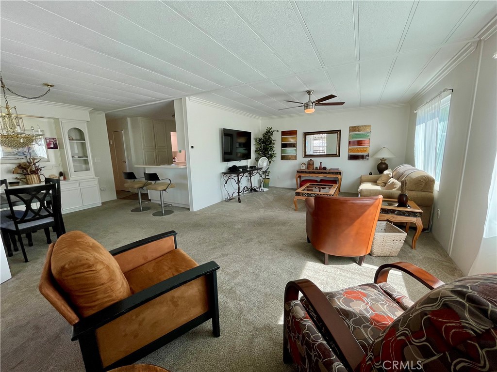 31130 South General Kearny Road, Unit 145 Temecula, CA 92591 - Photo 5 of 27 a living room with furniture ceiling fan and a window