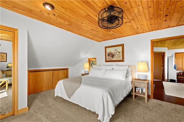 a bedroom with a bed and a painting on the wall