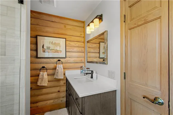 a bathroom with a sink vanity and a mirror