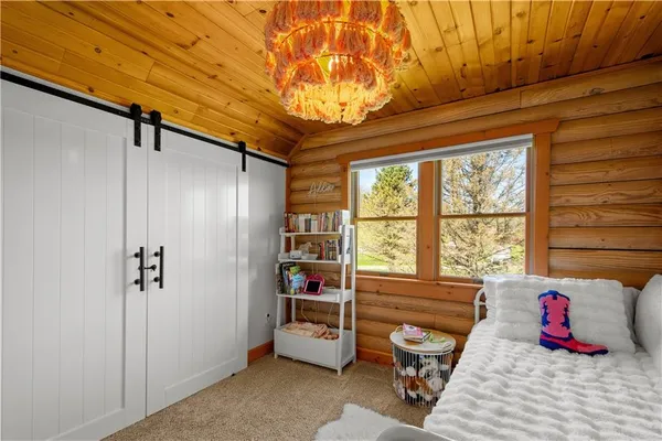 a bedroom with furniture and a window