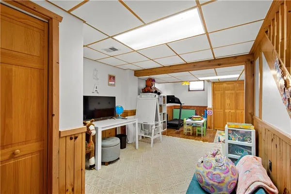 a room with furniture a flat screen tv and a window