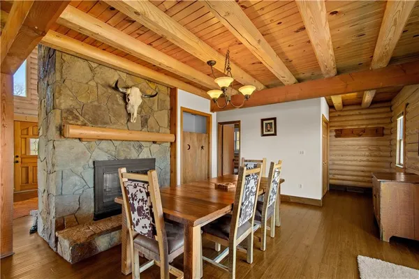 a dining room with furniture and wooden floor