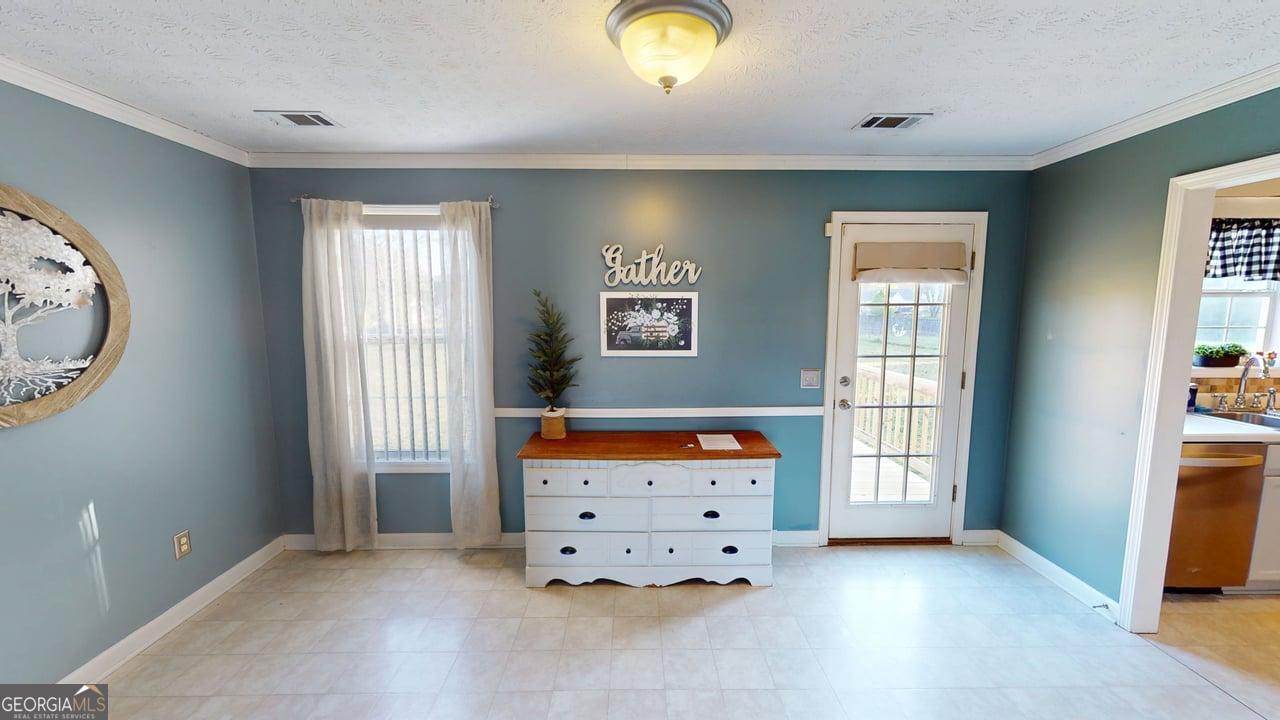 2124 Broad Street Statham, GA 30666 - Photo 11 of 35 an empty room with window and dresser