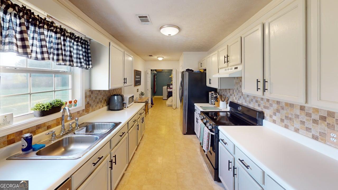 2124 Broad Street Statham, GA 30666 - Photo 13 of 35 a kitchen with a sink and a stove top oven