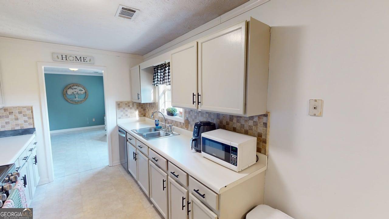 2124 Broad Street Statham, GA 30666 - Photo 14 of 35 a bathroom with a sink and a mirror