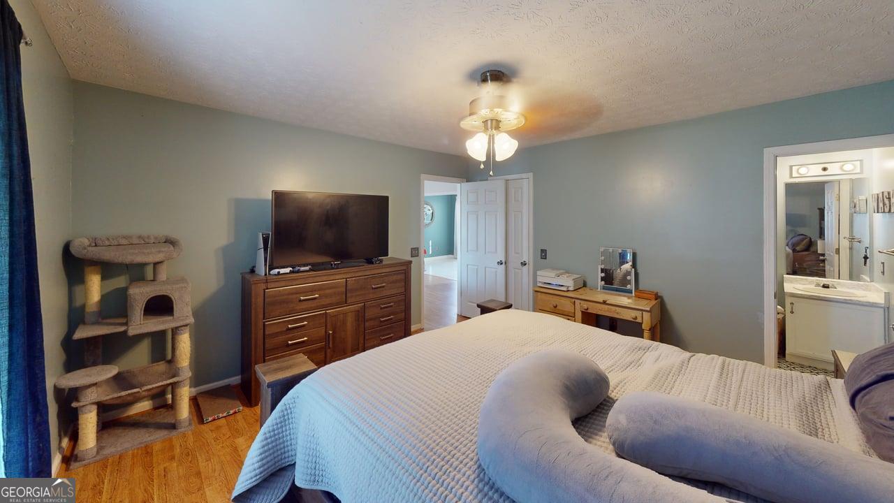 2124 Broad Street Statham, GA 30666 - Photo 19 of 35 a bedroom with a bed and a flat screen tv