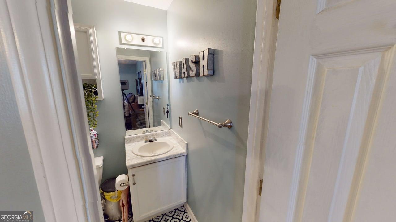2124 Broad Street Statham, GA 30666 - Photo 21 of 35 a bathroom with a sink and mirror