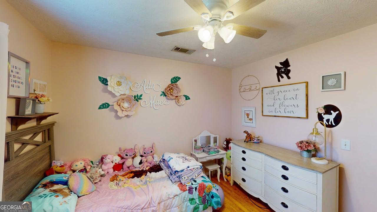 2124 Broad Street Statham, GA 30666 - Photo 29 of 35 a bed room with a baby bed