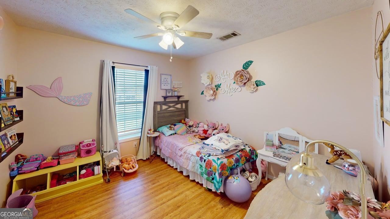 2124 Broad Street Statham, GA 30666 - Photo 31 of 35 a bedroom with toys and a wooden floor