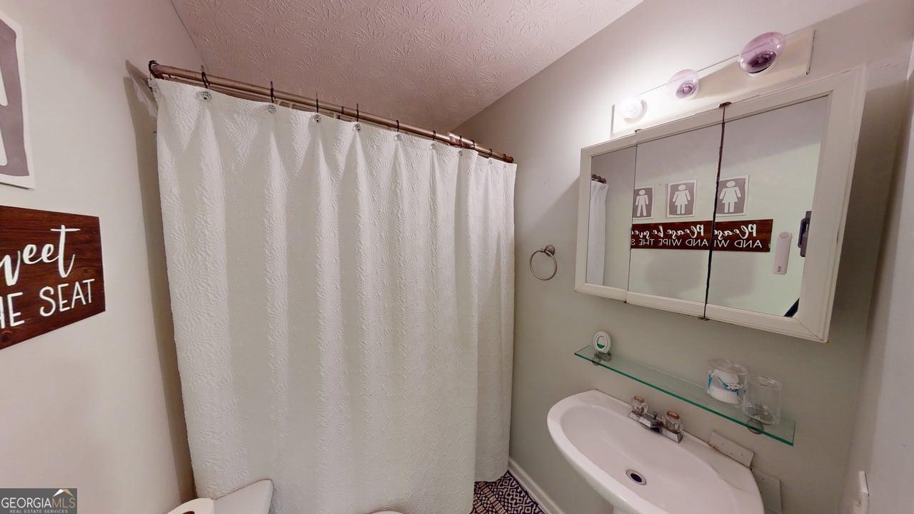 2124 Broad Street Statham, GA 30666 - Photo 32 of 35 a bathroom with a sink and mirror
