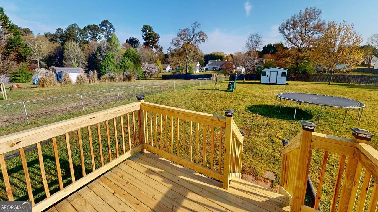 2124 Broad Street Statham, GA 30666 - Photo 35 of 35 a view of a swimming pool with a patio and a yard