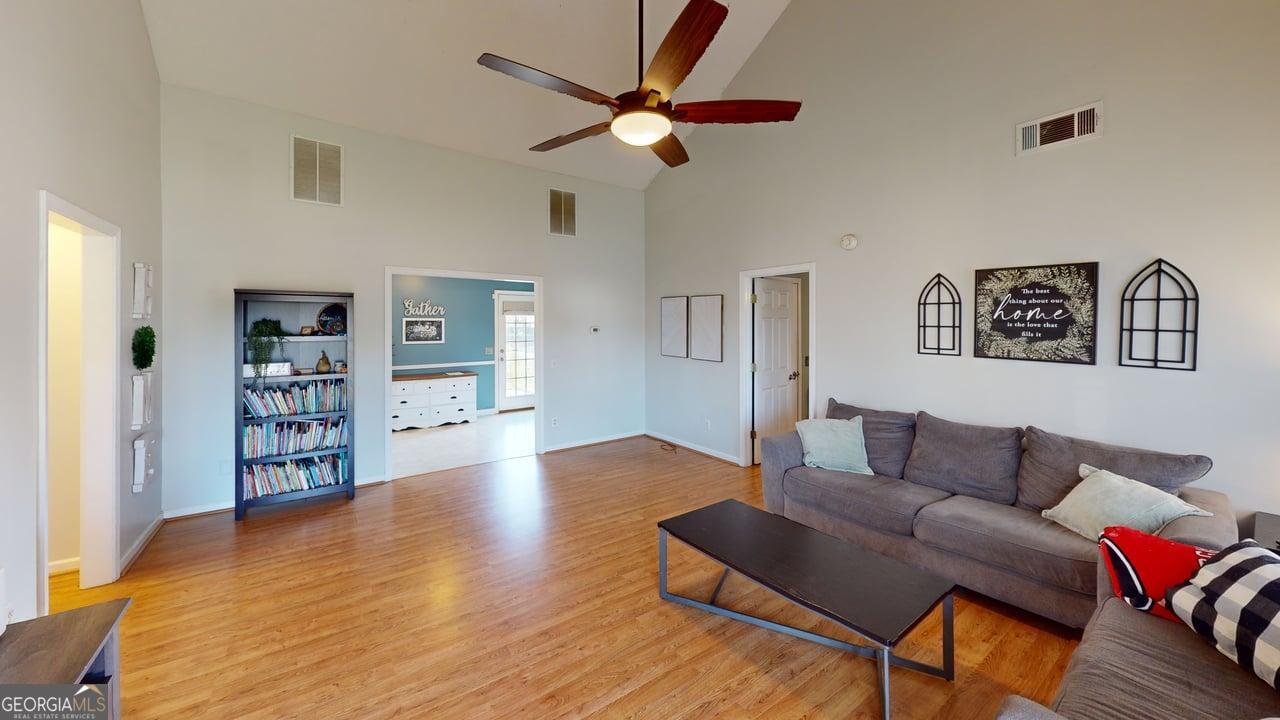 2124 Broad Street Statham, GA 30666 - Photo 4 of 35 a living room with furniture and a wooden floor