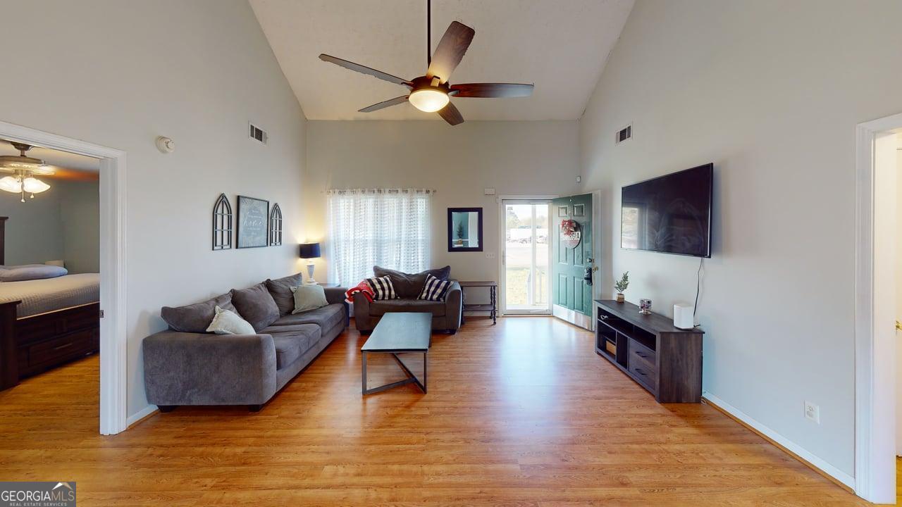 2124 Broad Street Statham, GA 30666 - Photo 9 of 35 a living room with fireplace furniture and a flat screen tv