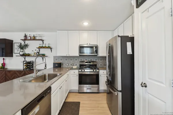 a kitchen with a sink stainless steel appliances and cabinets