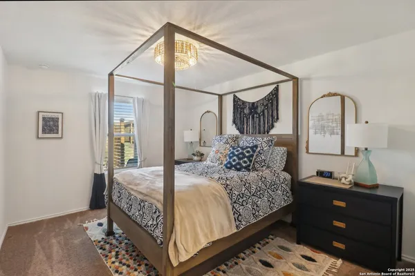 a bedroom with bed and a window