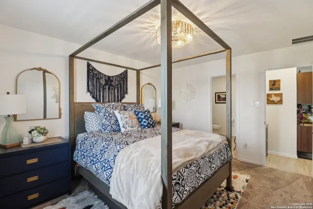 a bedroom with a large bed and a dresser