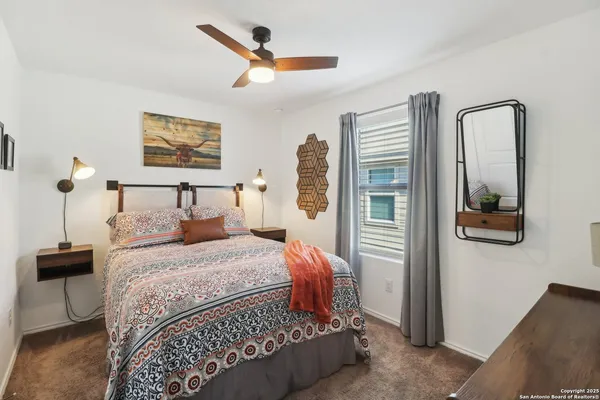 a bedroom with a bed and a mirror