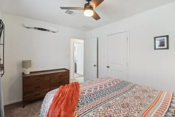 a bedroom with a bed and a dresser