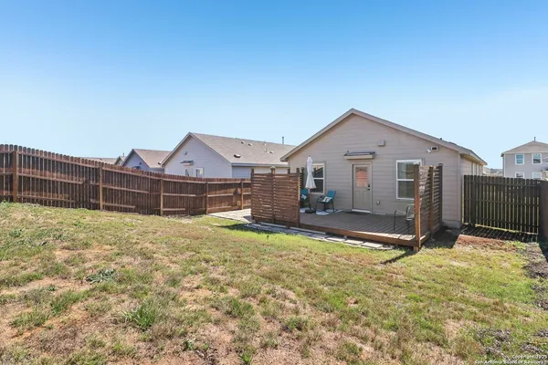 a view of a house with wooden fence