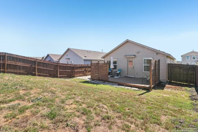 a view of a house with wooden fence