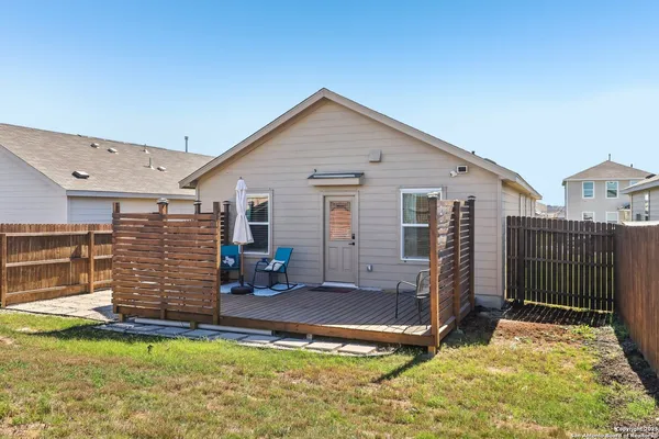a view of a house with a yard and furniture