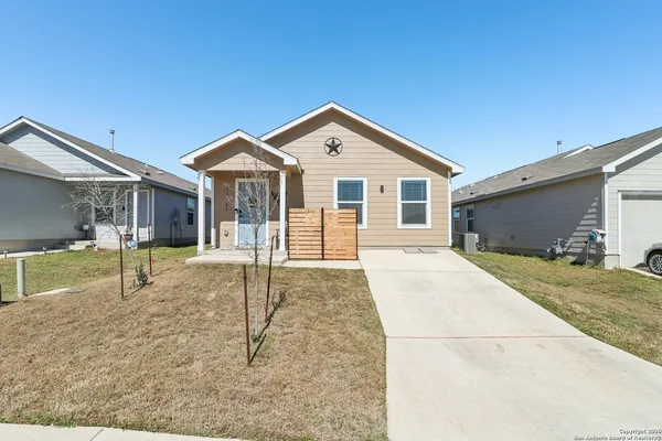 a front view of a house with a yard