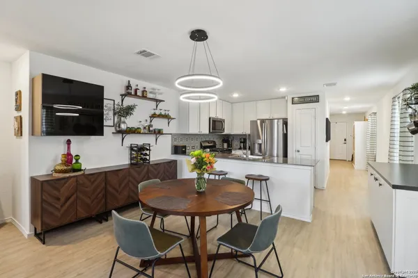 a kitchen with a table and chairs in it