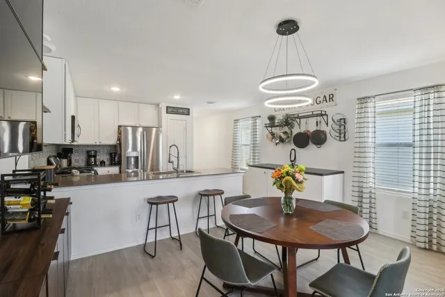 a kitchen with a table chairs stove and microwave