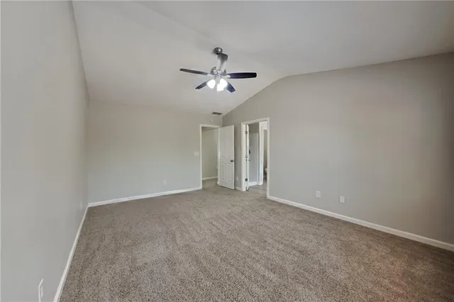 a view of an empty room with a ceiling fan
