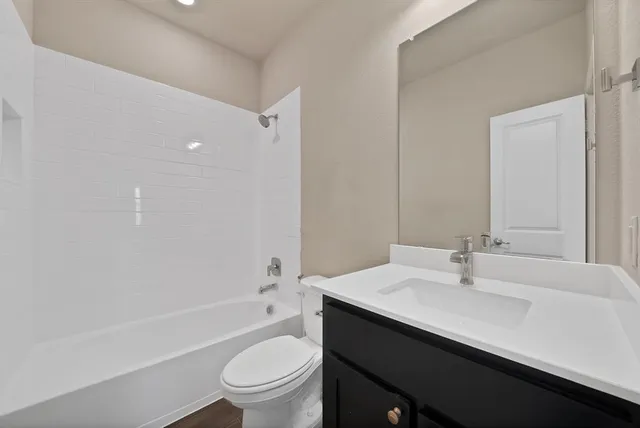 an empty room with closet and windows