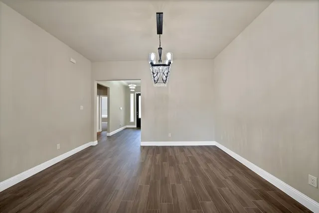 a view of a room with wooden floor and window