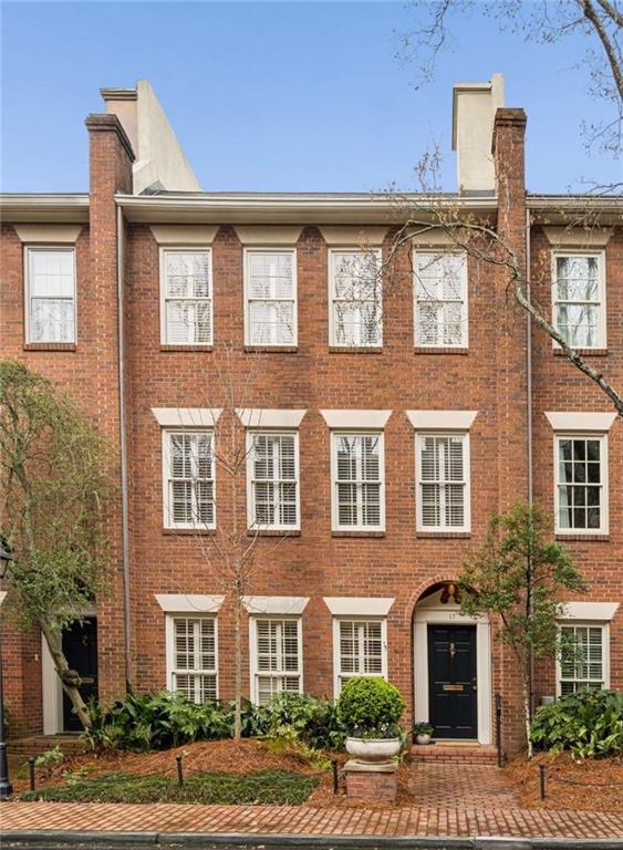 a front view of a building with a yard