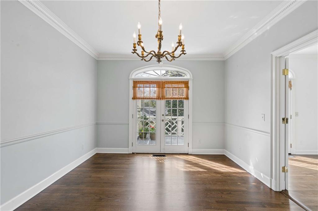17 Muscogee Way Northwest Atlanta, GA 30305 - Photo 9 of 40 an empty room with wooden floor chandelier and windows