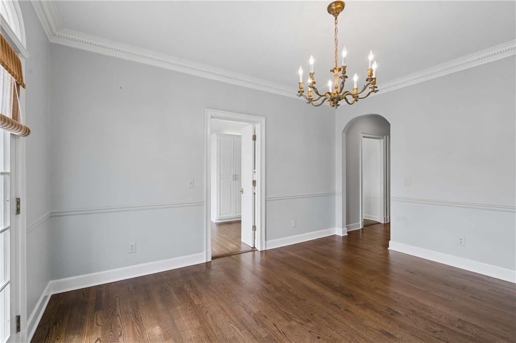 17 Muscogee Way Northwest Atlanta, GA 30305 - Photo 10 of 40 a view of an empty room with wooden floor and chandelier