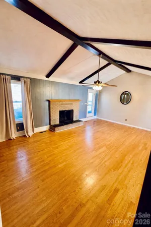 a view of an empty room with a fireplace