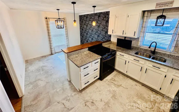 a kitchen with stainless steel appliances granite countertop a stove and a sink