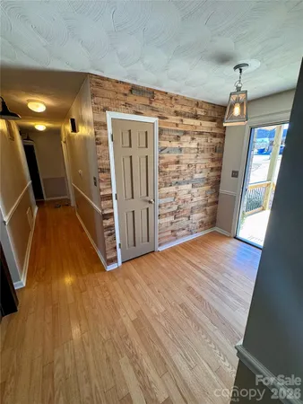 a view of a room with wooden floor