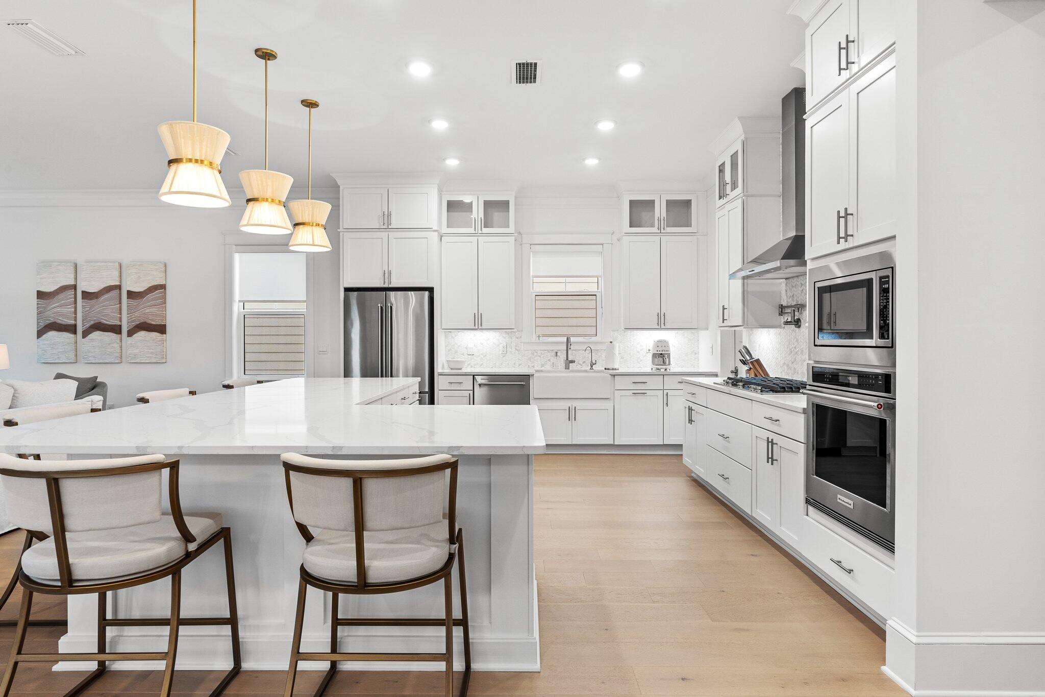 105 Seaboard Lane Santa Rosa Beach, FL 32459 - Photo 11 of 54 a kitchen with stainless steel appliances kitchen island granite countertop a sink and cabinets