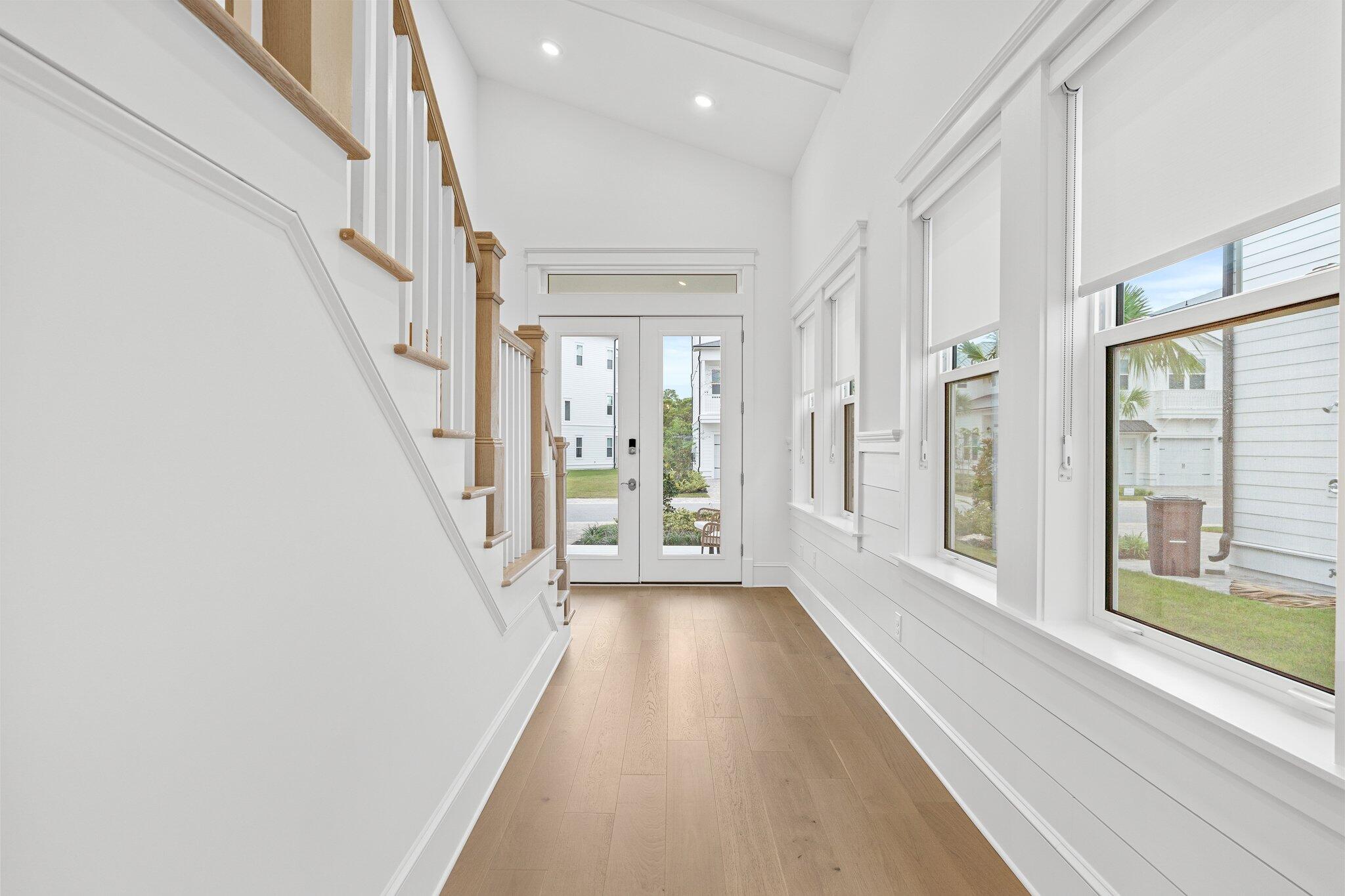 105 Seaboard Lane Santa Rosa Beach, FL 32459 - Photo 19 of 54 a view of a hallway with wooden floor and staircase