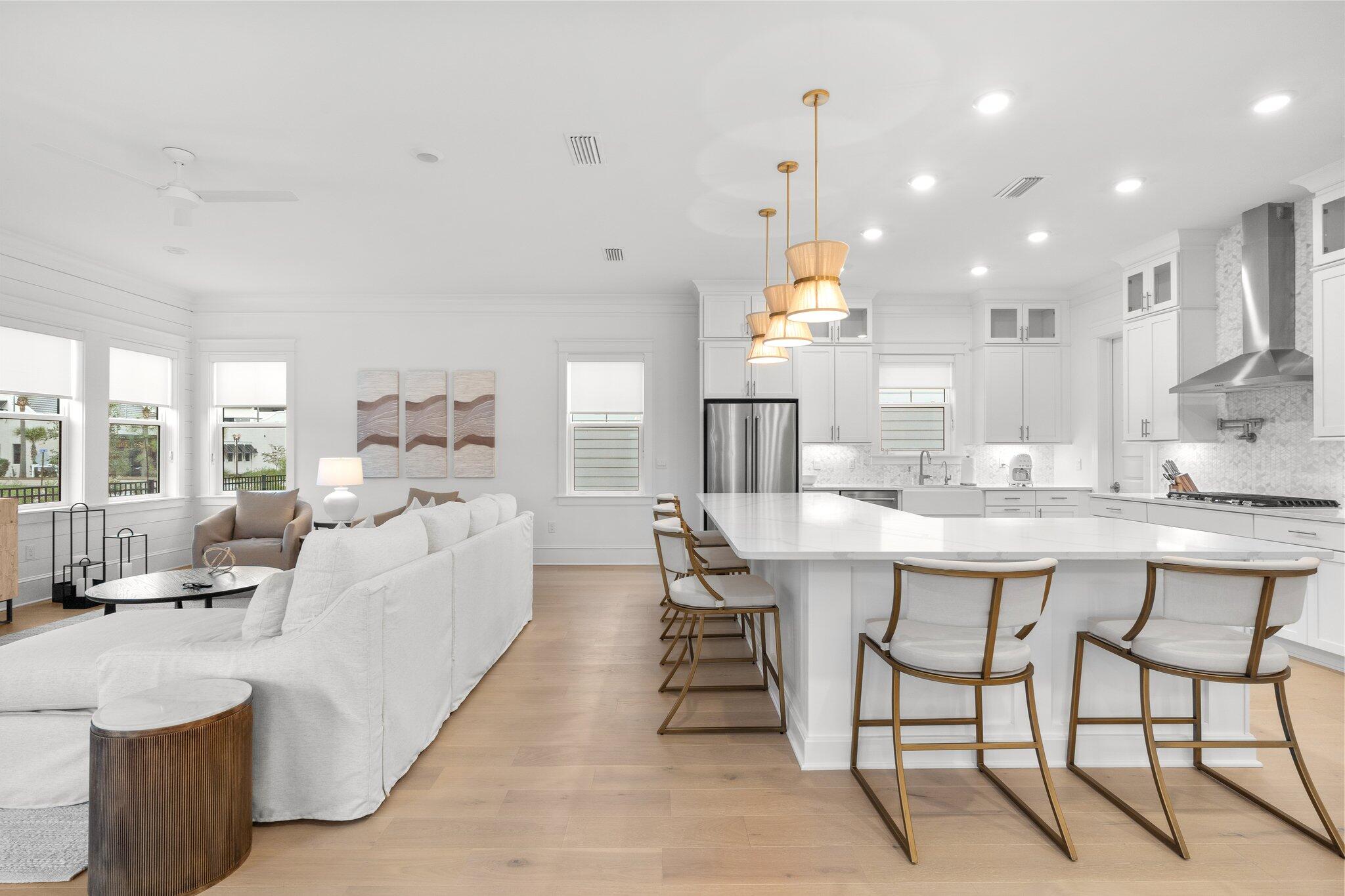 105 Seaboard Lane Santa Rosa Beach, FL 32459 - Photo 3 of 54 a large white kitchen with a large island oven a sink and a large window