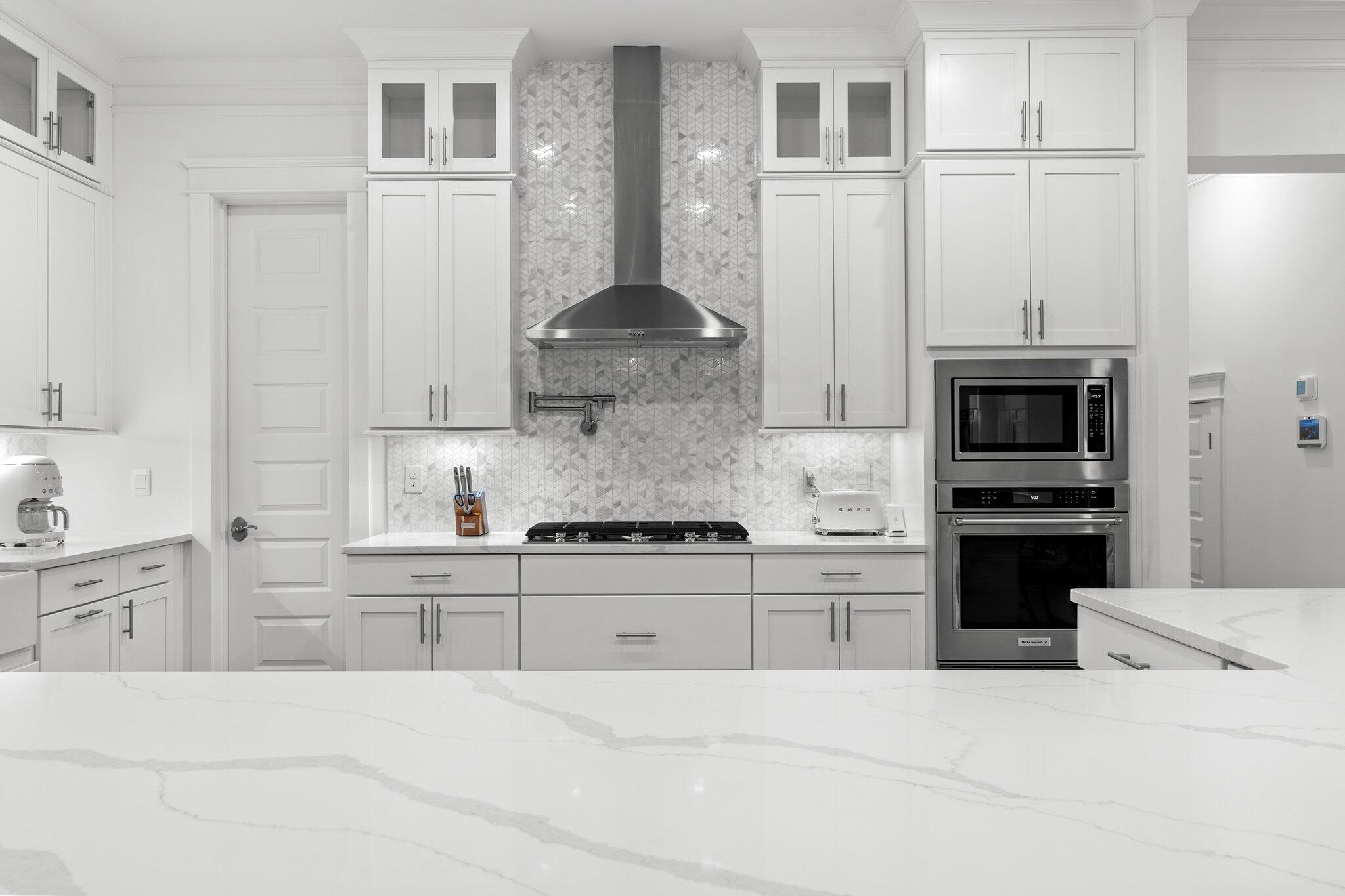 105 Seaboard Lane Santa Rosa Beach, FL 32459 - Photo 9 of 54 a kitchen with granite countertop a stove sink and refrigerator