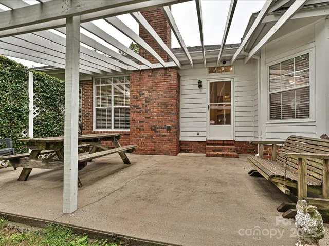 a backyard of a house with outdoor seating