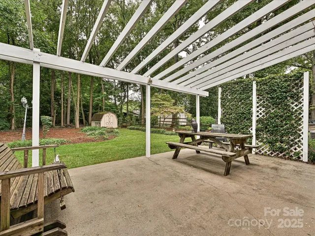 a view of a patio with a table chairs and a backyard