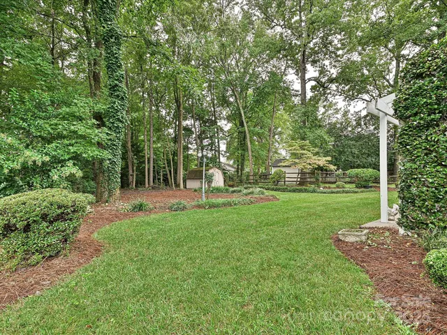 a view of a park with trees in the background